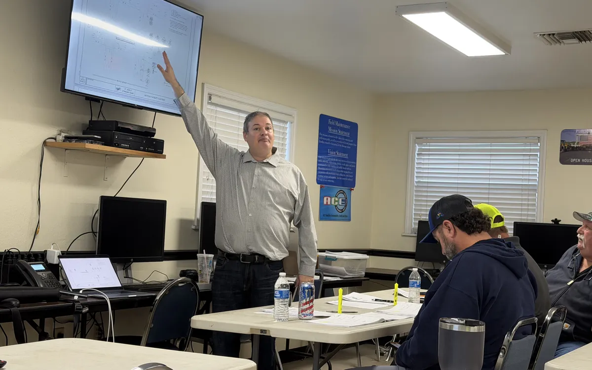 Instructor explaining a temporary traffic control diagram to participants in an onsite classroom.